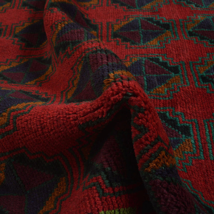 Red Afghan Baluchi Rug 4' 0" x 6' 7" Hand-Knotted texture
