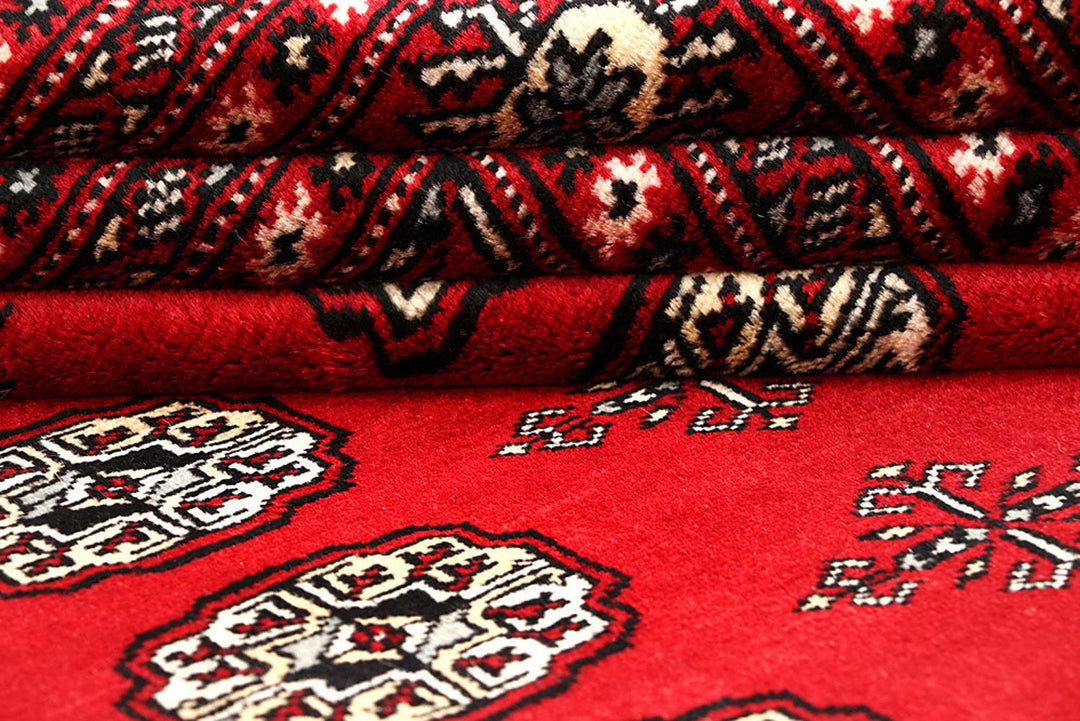 Red Pakistani Bokhara Rug 6' 1" x 8' 11" Hand-Knotted | No. QA15645