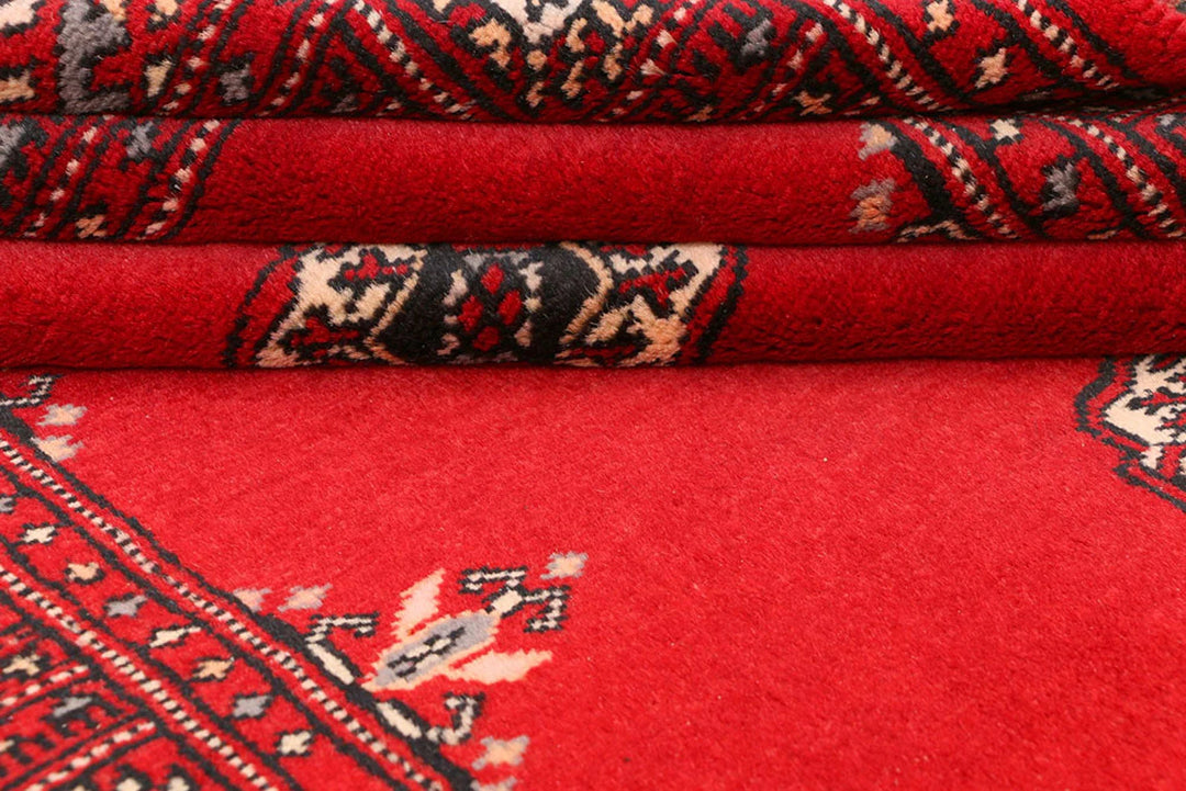 Red Pakistani Bokhara Rug 3' 1" x 5' 7" Hand-Knotted | No. QA21057