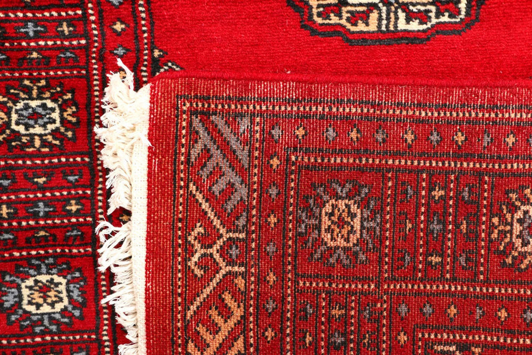 Red Pakistani Bokhara Rug 2' 7" x 8' 11" Hand-Knotted | No. QA27636