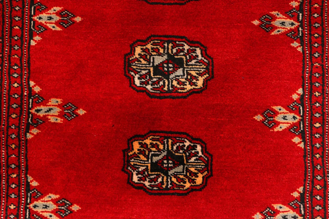 Red Pakistani Bokhara Rug 2' 7" x 9' 3" Hand-Knotted | No. QA29390