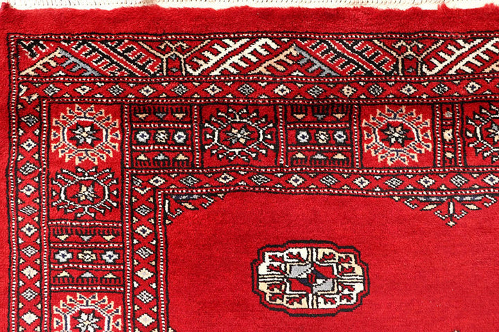 Red Pakistani Bokhara Rug 4' 1" x 6' 9" Hand-Knotted | No. QA34448