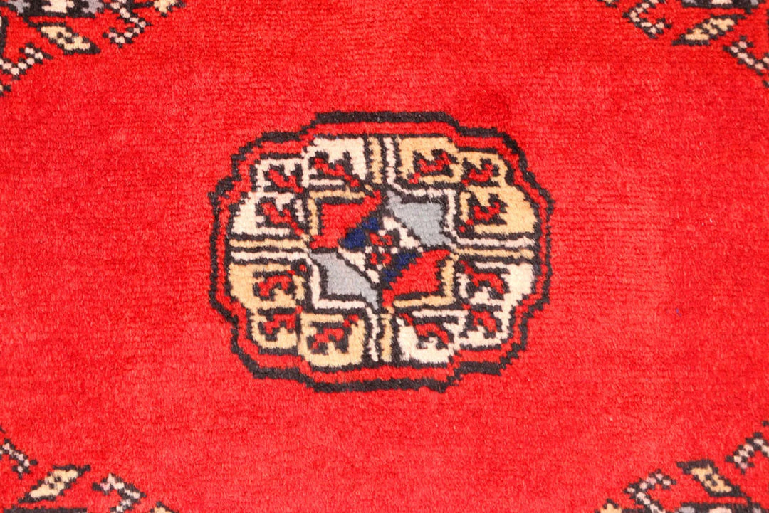 Red Pakistani Bokhara Rug 2' 6" x 10' 8" Hand-Knotted | No. QA48610