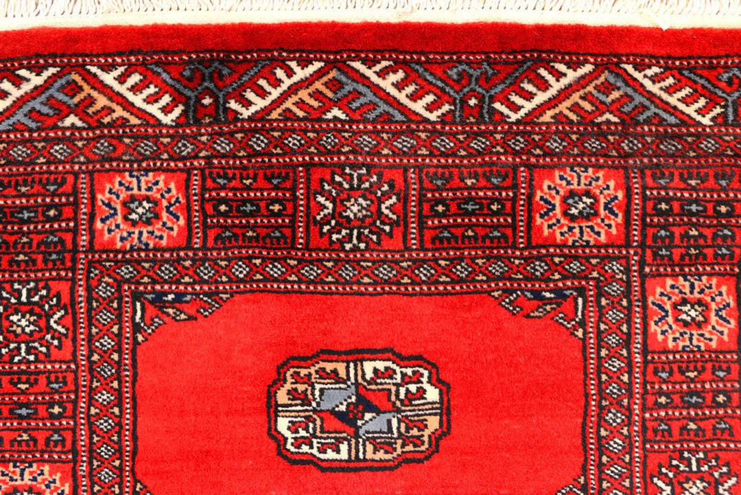 Red Pakistani Bokhara Rug 2' 7" x 11' 9" Hand-Knotted | No. QA55512