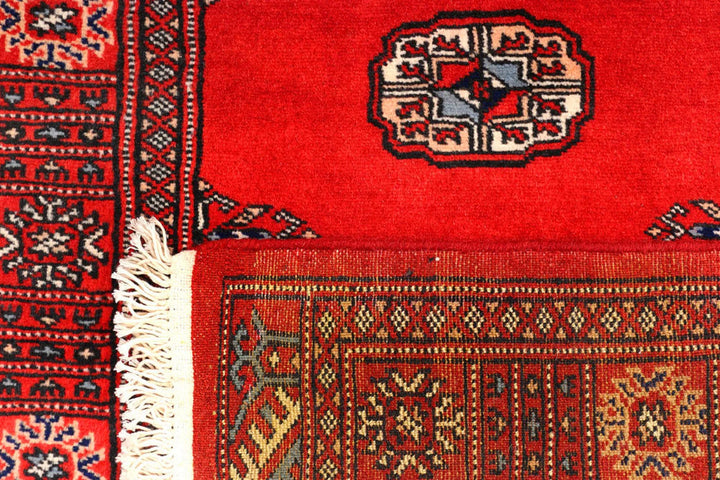 Red Pakistani Bokhara Rug 2' 7" x 11' 9" Hand-Knotted | No. QA55512