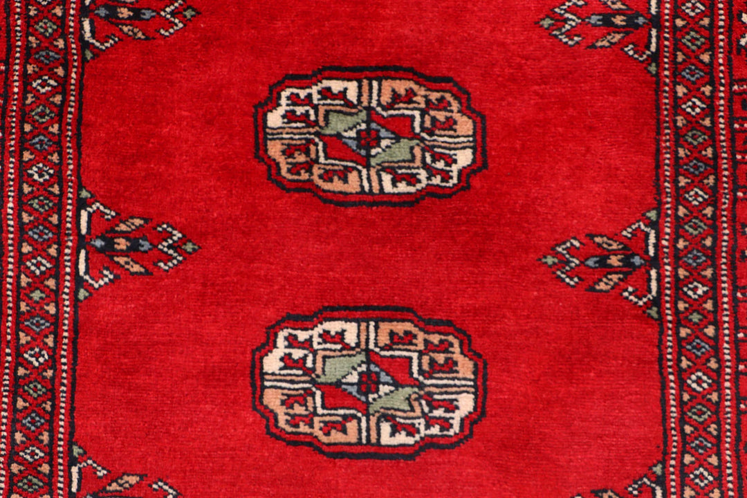 Red Pakistani Bokhara Rug 2' 6" x 10' 3" Hand-Knotted | No. QA56773