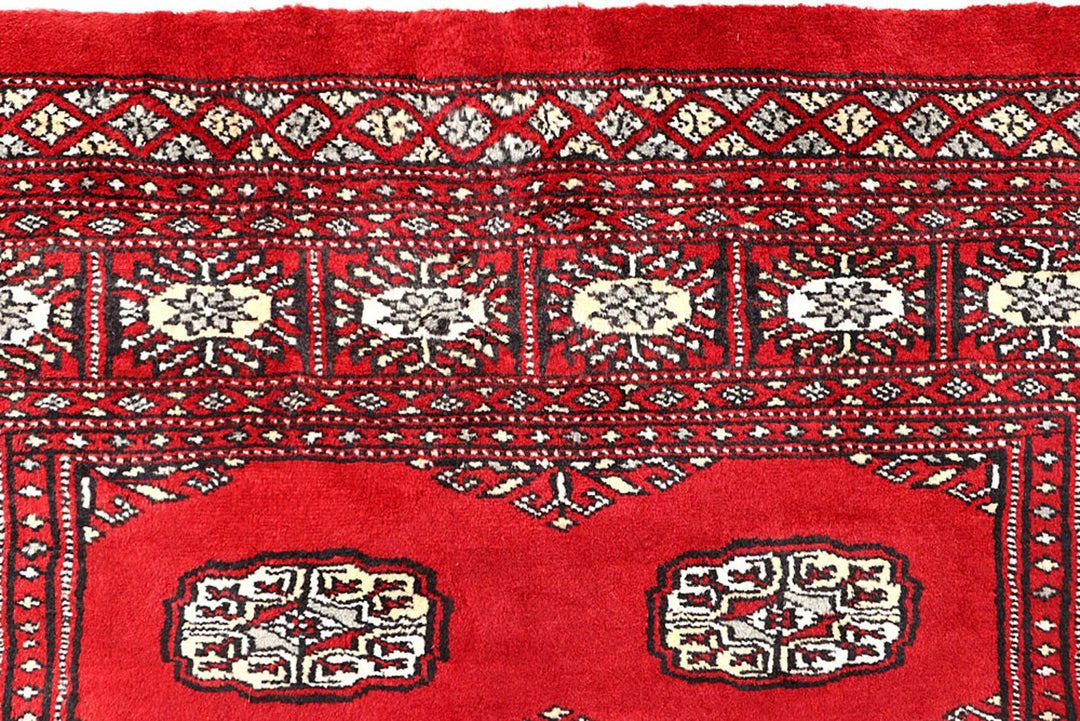 Red Pakistani Bokhara Rug 4' 2" x 6' 5" Hand-Knotted | No. QA61648