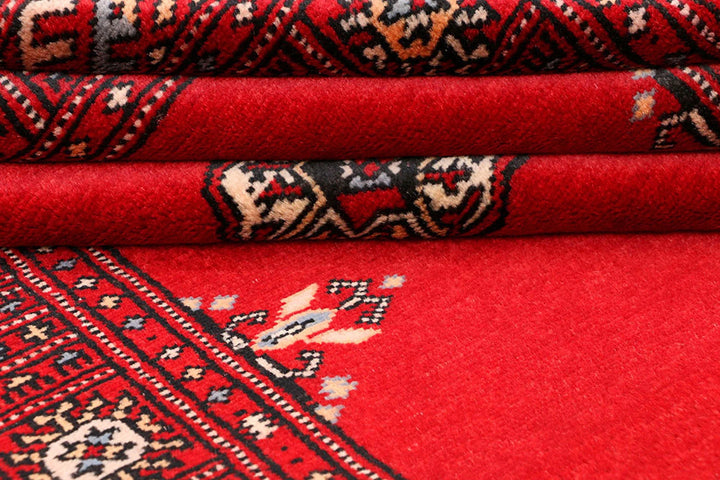 Red Pakistani Bokhara Rug 3' 1" x 5' 7" Hand-Knotted | No. QA68637