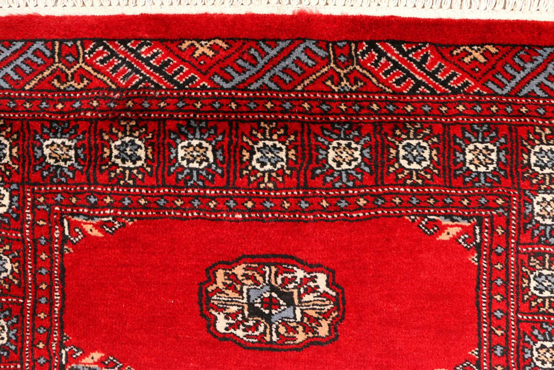 Red Pakistani Bokhara Rug 2' 6" x 9' 5" Hand-Knotted | No. QA72992