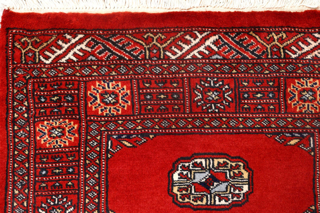 Red Pakistani Bokhara Rug 2' 7" x 10' 1" Hand-Knotted | No. QA86515