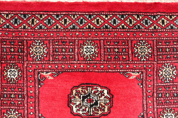 Red Pakistani Bokhara Rug 2' 7" x 11' 6" Hand-Knotted | No. QA88821