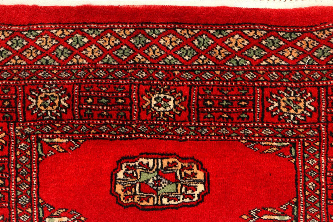 Red Pakistani Bokhara Rug 2' 7" x 9' 5" Hand-Knotted | No. QA93872