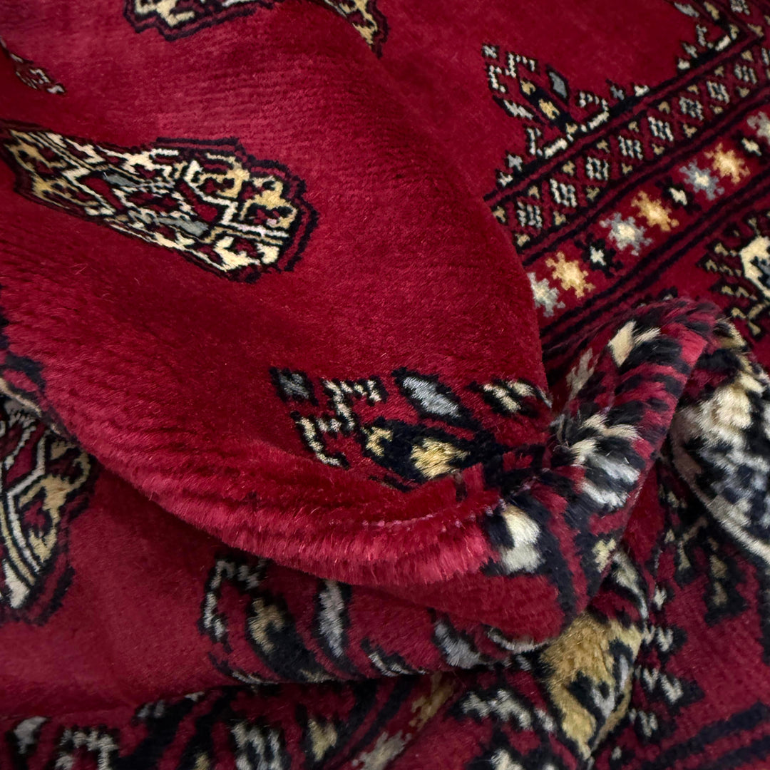 Vibrant Red Pakistani Bokhara Rug 4'1" x 5'10" Hand-Knotted texture