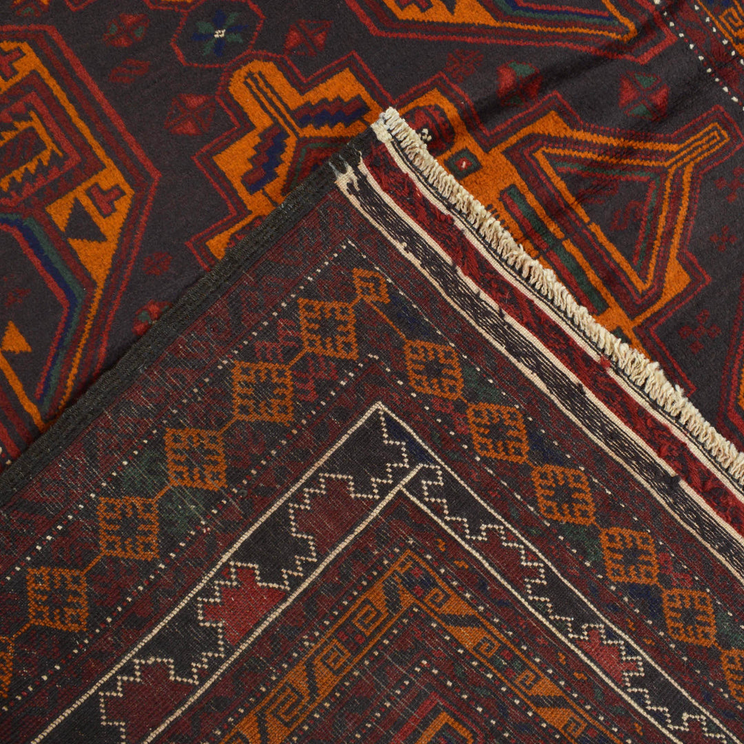 Afghan Baluchi Rug 4' 2" x 6' 3" Hand-Knotted close-up