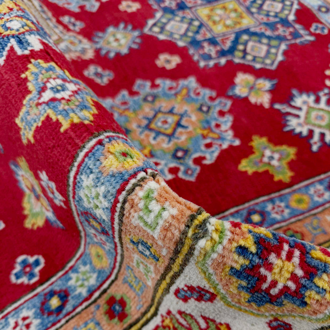 Red Afghan Kazak Rug 4' 8" x 6' 7" Hand-Knotted texture